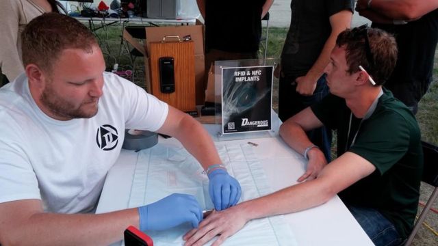 Dangerous Things CEO Amal Graafstra installs a microchip at ToorCamp.