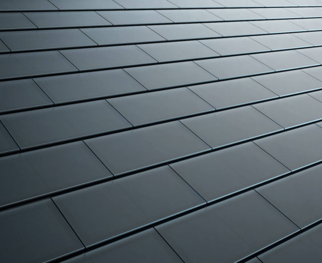 Tesla smooth black glass solar roof tiles. 