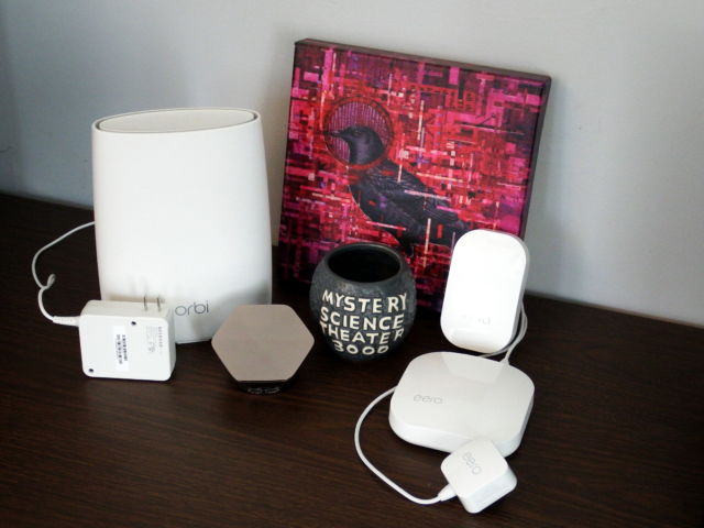 Plume's new Superpod design is shown here next to an Orbi RBS-50 satellite, an Eero router, and an Eero beacon. The Superpod is roughly the size of Orbi's power brick, without the actual Orbi.