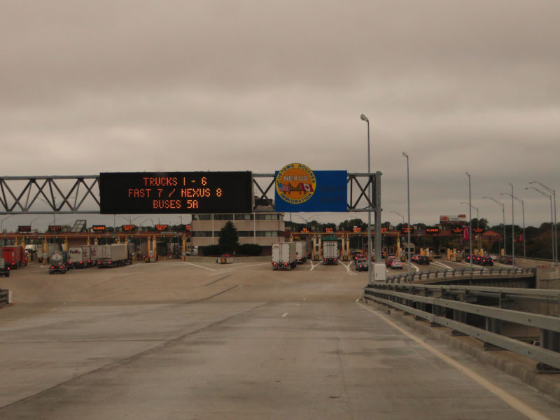 A multilane highway meets a large border station.