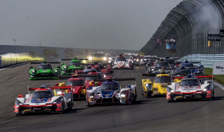 Cars race into the first turn at the start of the Sahlens Six Hours of the Glen IMSA WeatherTech Series race at Watkins Glen International on July 1, 2018 in Watkins Glen, New York.