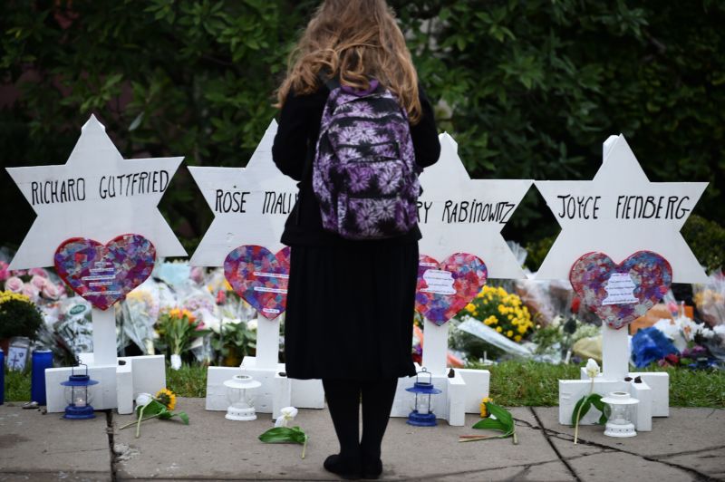 A woman stands at a memorial outside the Tree of Life synagogue after a shooting there left 11 people dead in the Squirrel Hill neighborhood of Pittsburgh on October 27.