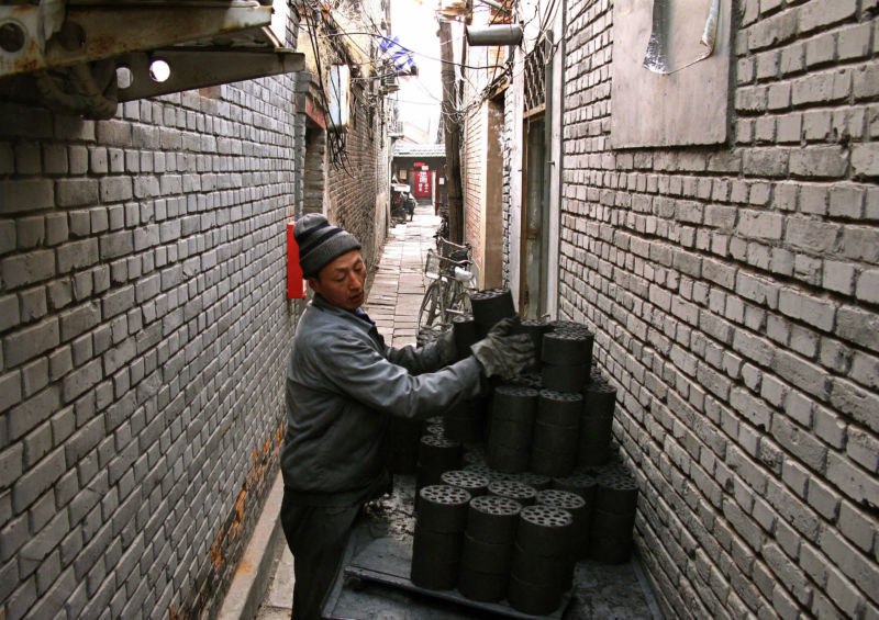 Vendor delivering coal briquettes