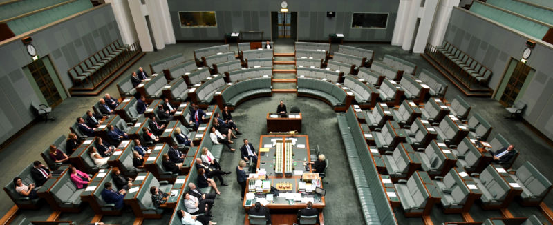 Large room full of well-dressed men and women.