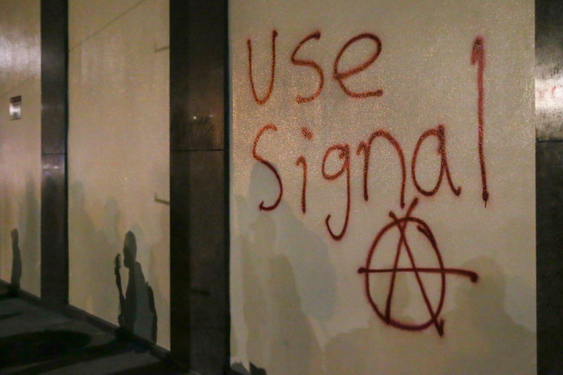 Graffiti urging people to use Signal, a highly-encrypted messaging app, is spray-painted on a wall during a protest on February 1, 2017 in Berkeley, California.