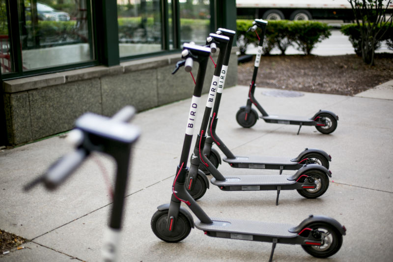 A row of parked electric scooters.