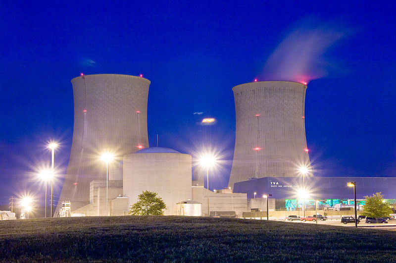 A pair of nuclear towers against a blue sky.