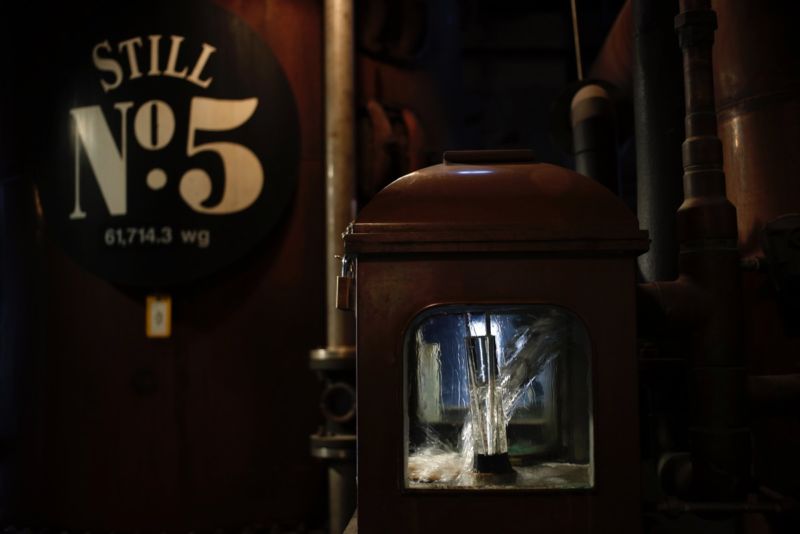 White lightning distilled alcohol streams out of a still. It must be filtered through charcoal before barrel aging to be legally branded "Tennessee whiskey."