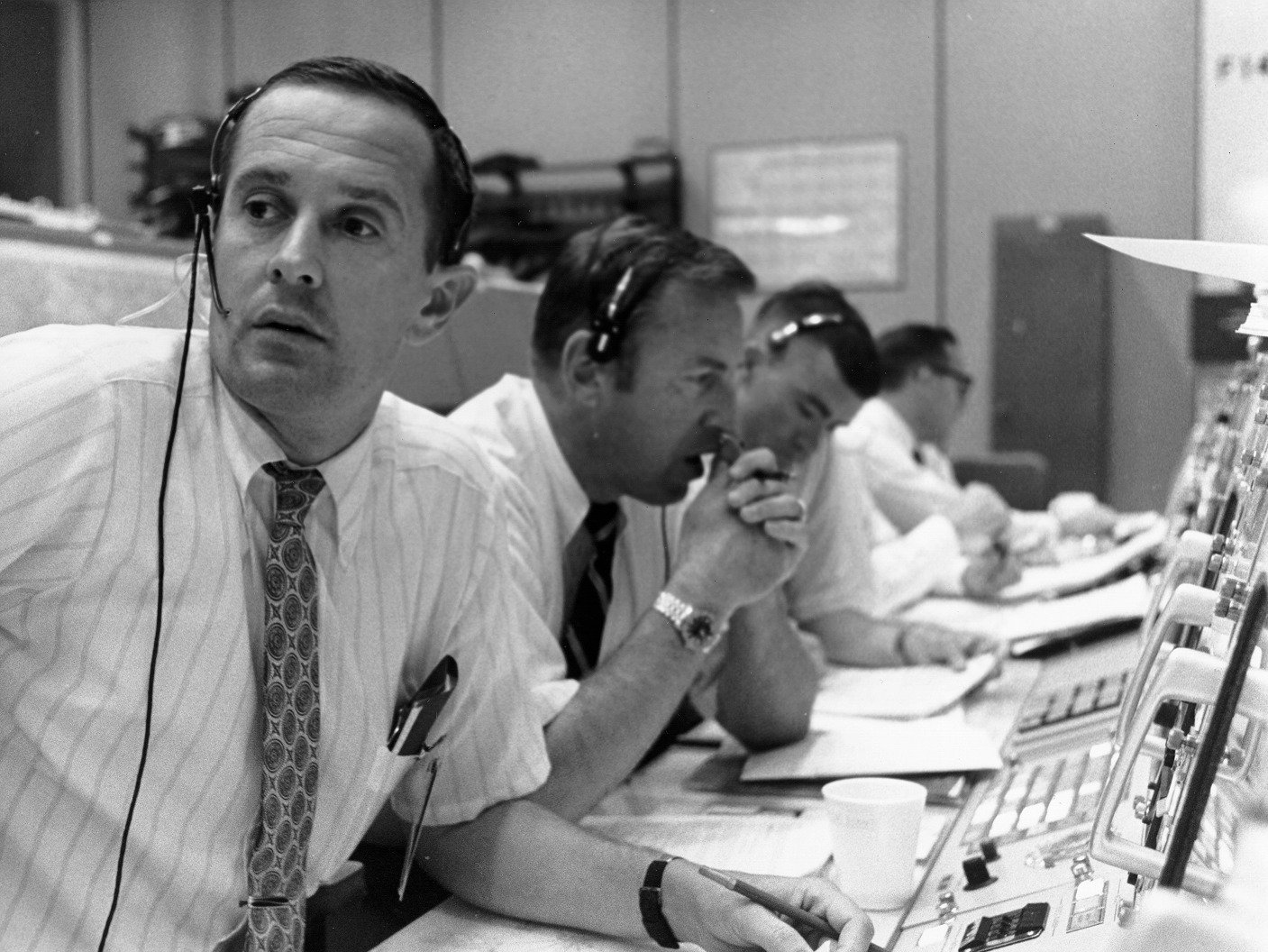 CAPCOM Charlie Duke (foreground) with backup commander Jim Lovell (center) during Apollo 11's tense landing.