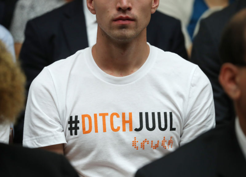 WASHINGTON, DC - JULY 25: A young man wears a shirt that reads DITCHJUUL while James Monsees, co-founder and chief product officer at JUUL Labs Inc., testifies before the House Economic and Consumer Policy Subcommittee, which is examining JUUL's role in the youth nicotine epidemic, on July 25, 2019 in Washington, DC. (Photo by Mark Wilson/Getty Images)