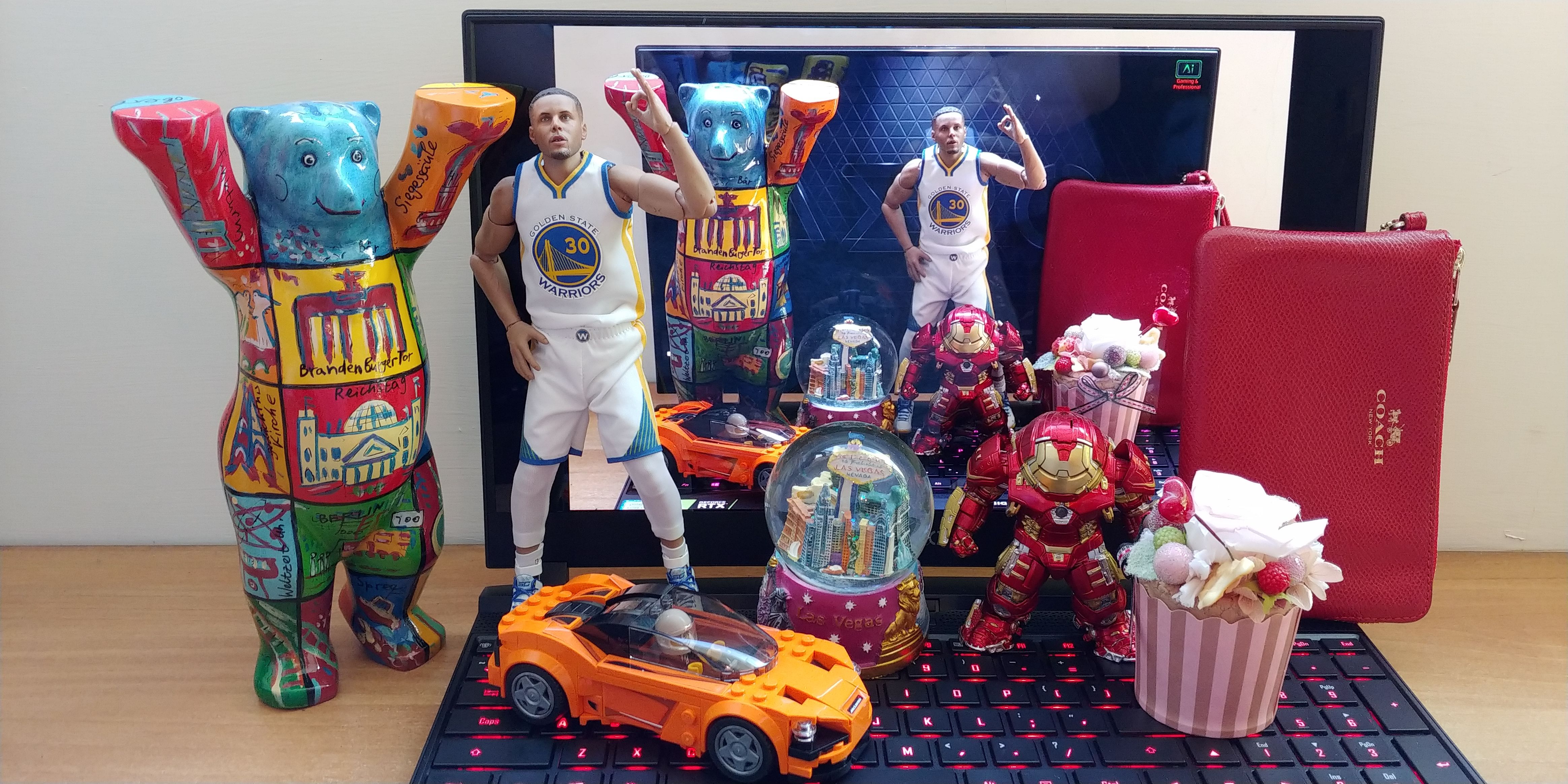 Image shows actual items of different materials and texture compared to a photo on the AERo 15 OLED screen which, has over 97% colour accuracy (Under 6500K colour temp. this gap will be over 99%), this is outstanding as professional display quality.