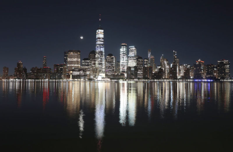 A crescent moon rises in the pre-dawn sky over the skyline of lower Manhattan and One World Trade Center in New York City on October 25, 2019 as seen from Jersey City, New Jersey.