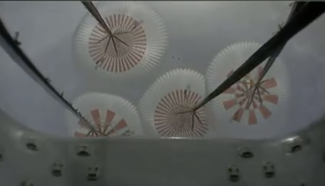 The view upwards from the Dragon capsule as its chutes deployed.