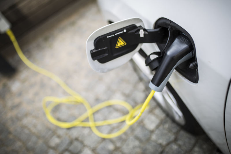 An electric car is pictured during charging on April 24, 2018 in Berlin, Germany