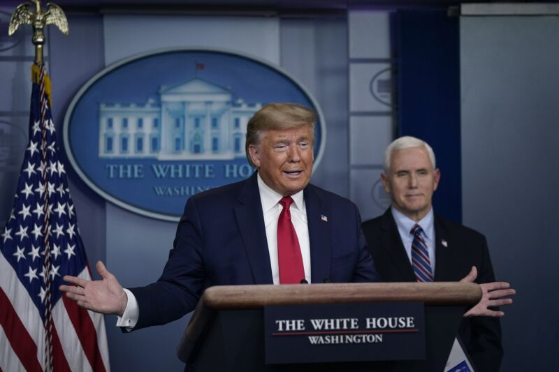 President Trump speaking in front of a podium at a daily briefing.