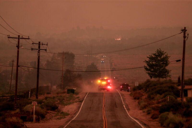Juniper Hills, CA, Thursday, Sept. 17, 2020 - A fire engine drives into air thick with smoke along Juniper Hills Rd. as the Bobcat Fire advances North into the Antelope Valley. 
