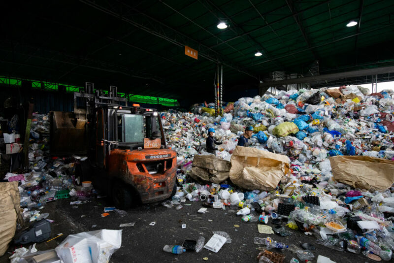 Image of a forklift surrounded by plastic bottles.