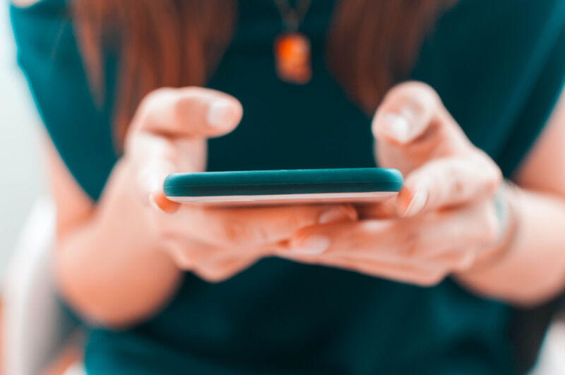 A young woman is using her smartphone