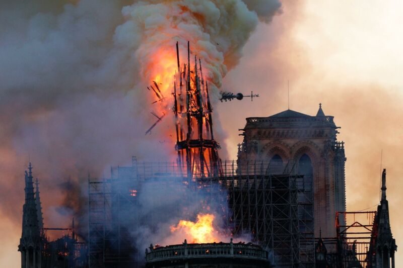 The iconic spire collapses as smoke and flames engulf the Notre Dame Cathedral in Paris on April 15, 2019.