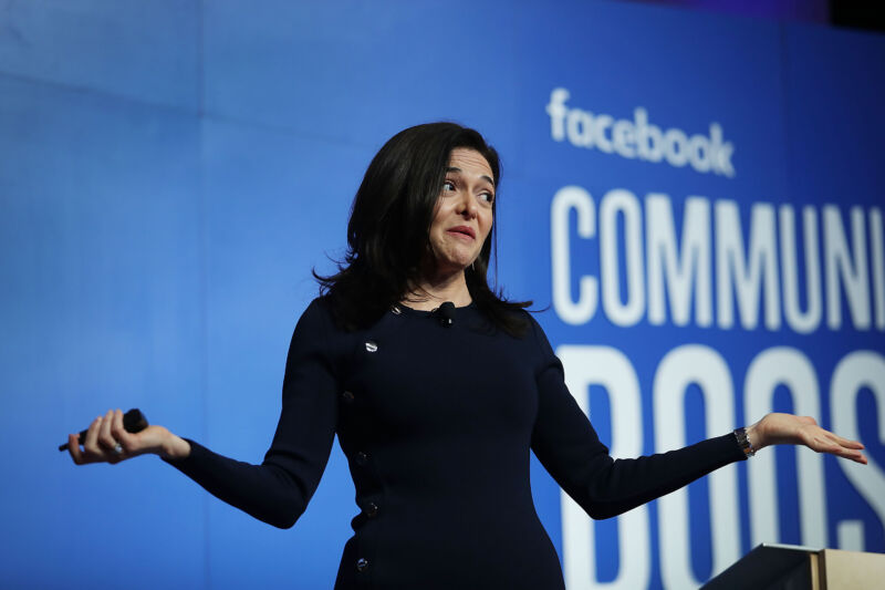 A woman shrugs onstage.