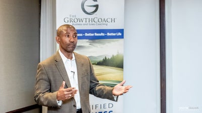 Business man speaking at a lecture.