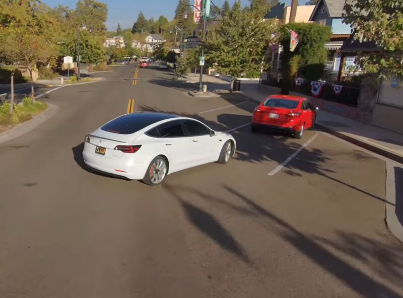 Two cars nearly collide in a parking lot.