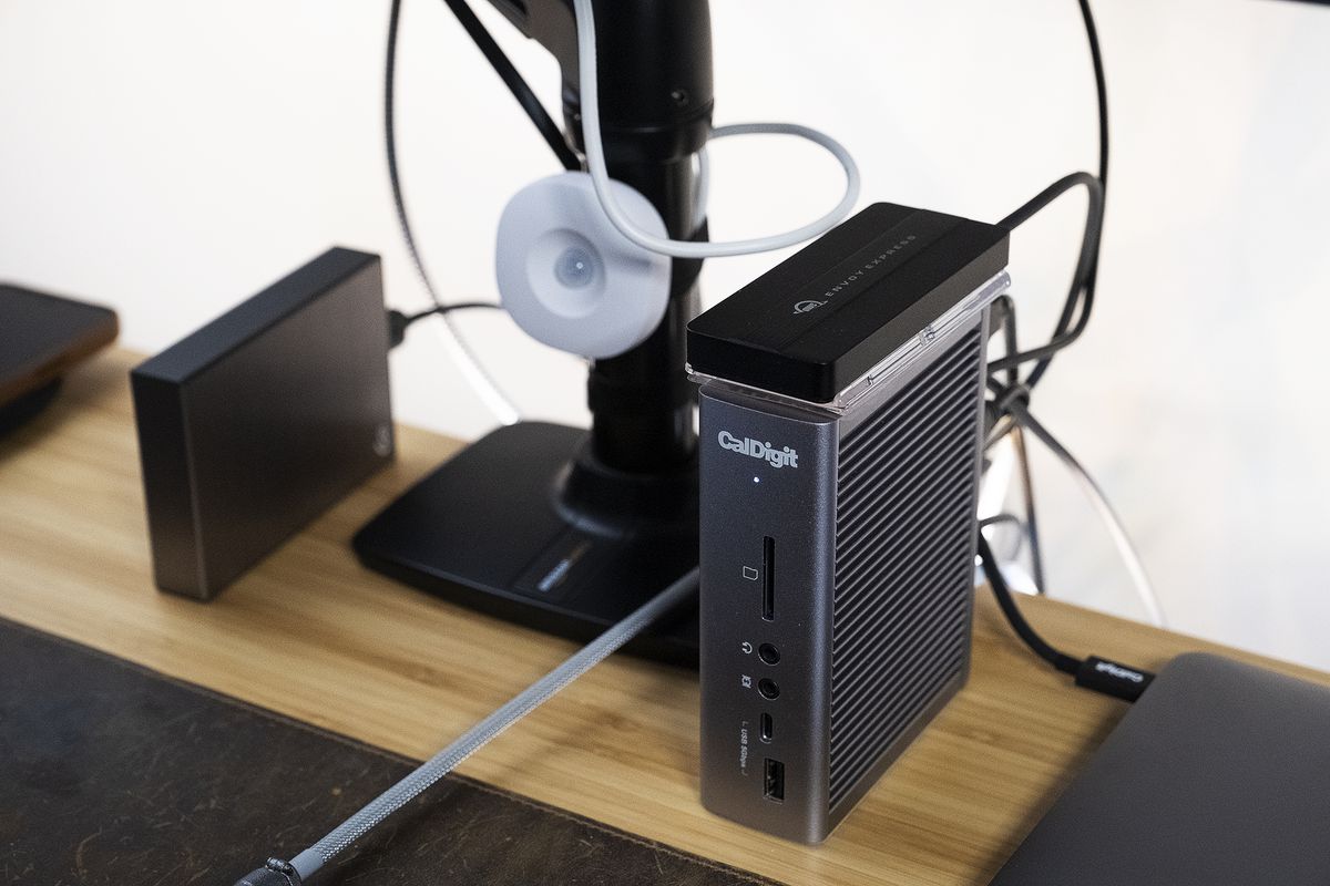 A SmartThings motion / temperature sensor hangs next to a CalDigit TS3 Plus Thunderbolt 3 dock.