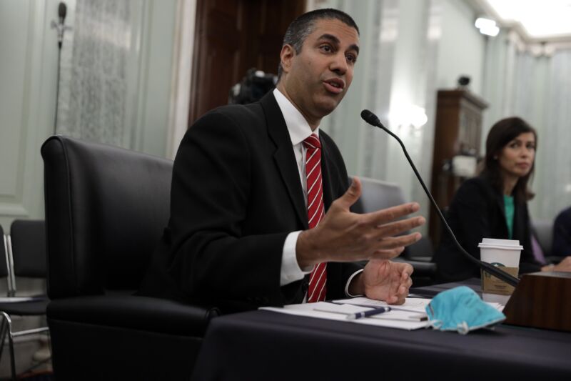 Then-FCC Chairman Ajit Pai and Commissioner Jessica Rosenworcel sit at a table while testifying at a Senate hearing.