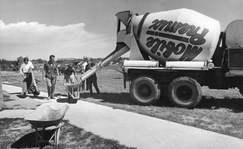 Black-and-white photograph of cement mixer at work.