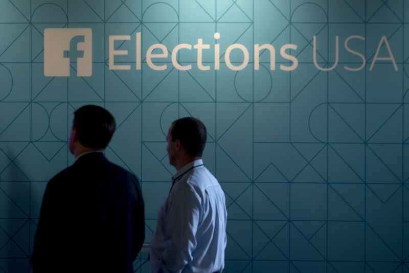 Guests stand next to a Facebook Elections USA sign in the Facebook Lounge ahead of the first Republican presidential debate at Quicken Loans Arena in Cleveland, Ohio, U.S., on Thursday, Aug. 6, 2015.