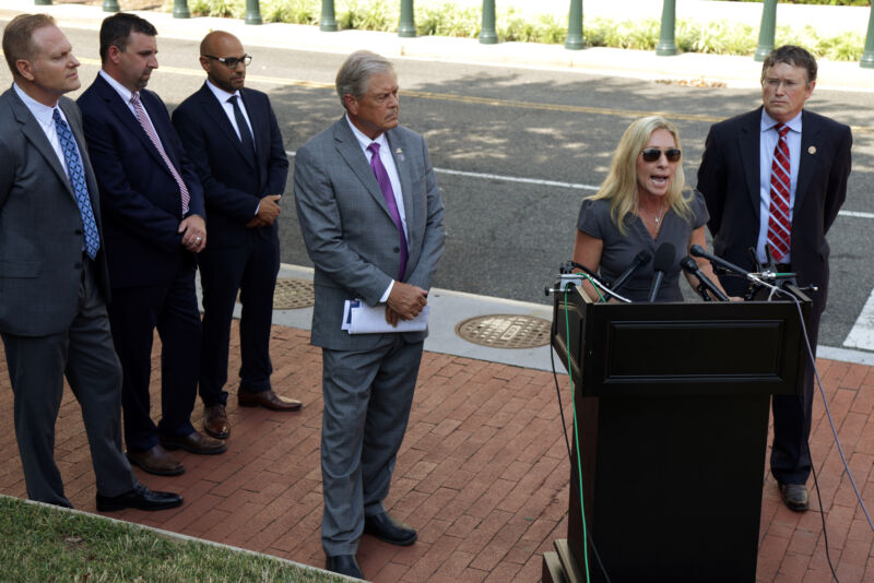 US Rep. Marjorie Taylor Greene (R-Ga.) speaks as Rep. Ralph Norman (R-S.C.) (3rd-R) and Rep. Thomas Massie (R-Ky.) (R) listen during a news conference outside the US Supreme Court on July 27, 2021, in Washington, DC.