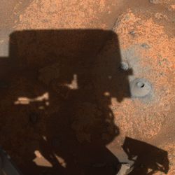 The hole Perseverance drilled on August 5th sitting to the right of the shadow of the rover’s turret.