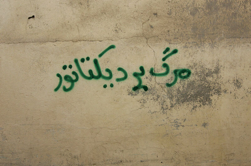An anti-government graffiti that reads in Farsi "Death to the dictator" is sprayed at a wall north of Tehran on September 30, 2009. 