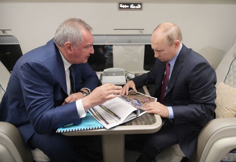 Russian President Vladimir Putin speaks with head of Russian space agency Roscosmos Dmitry Rogozin during a flight to the Vostochny cosmodrome, on September 4, 2021.