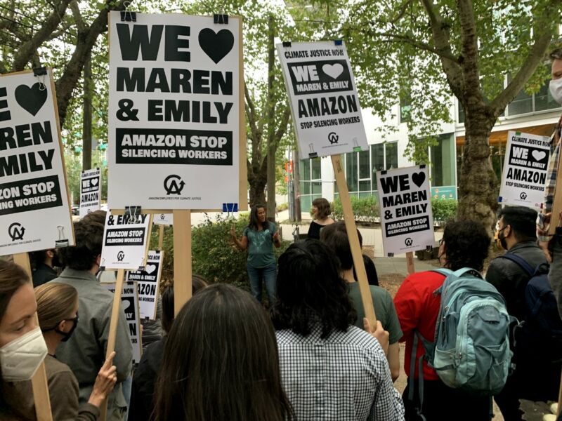 Rally of tech workers holding signs that say, 