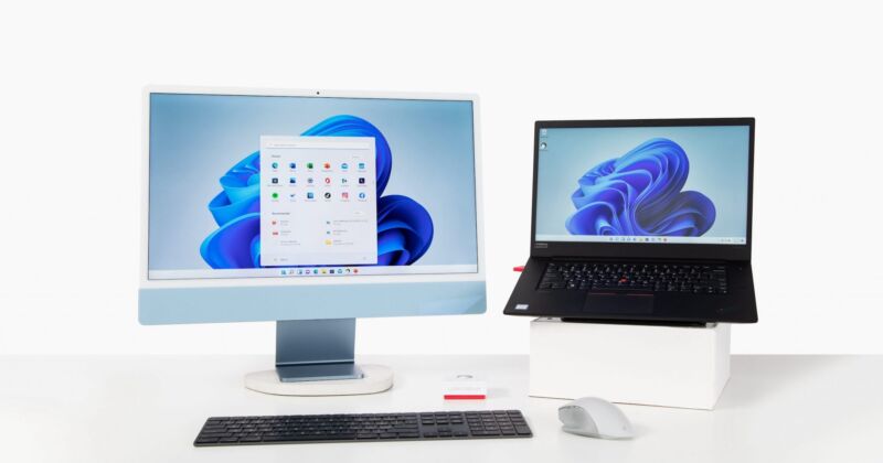 A 24-inch iMac used as display for a Windows 11-based Lenovo Thinkpad.
