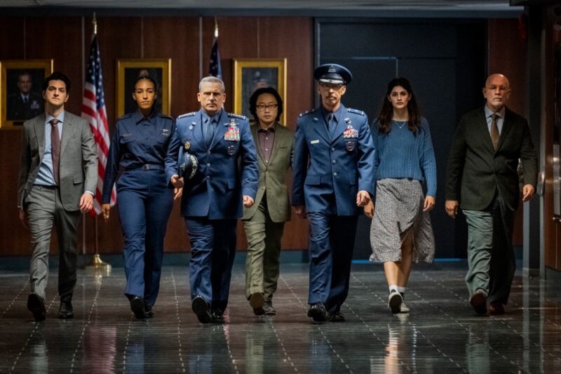 (l-r) Ben Schwartz as Tony Scarapiducci; Tawny Newsome as Angela Ali; Steve Carell as General Mark Naird; Jimmy O. Yang as Dr. Chan Kaifang; Don Lake as Brigadier General Bradley Gregory; Diana Silvers as Erin Naird; and John Malkovich as Dr. Adrian Mallory.