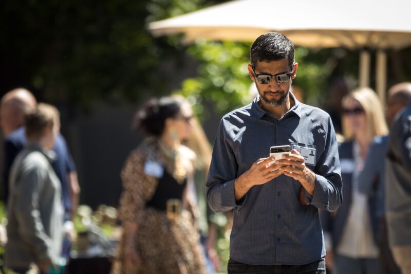 Google CEO Sundar Pichai looking at his phone.