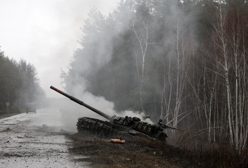 Smoke rises from a Russian tank destroyed by Ukrainian forces in the Luhansk region on February 26, 2022. (Photo by Anatolii Stepanov / AFP via Getty Images)