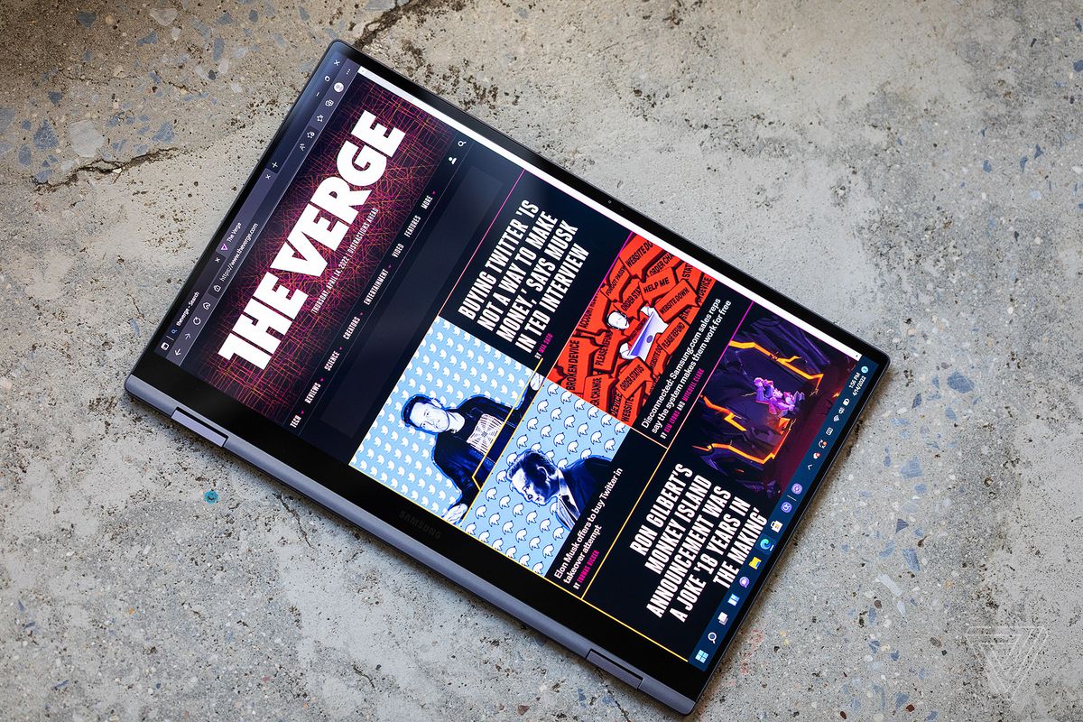 The Samsung Galaxy Book2 Pro 360 in tablet mode seen from above, displaying The Verge homepage.