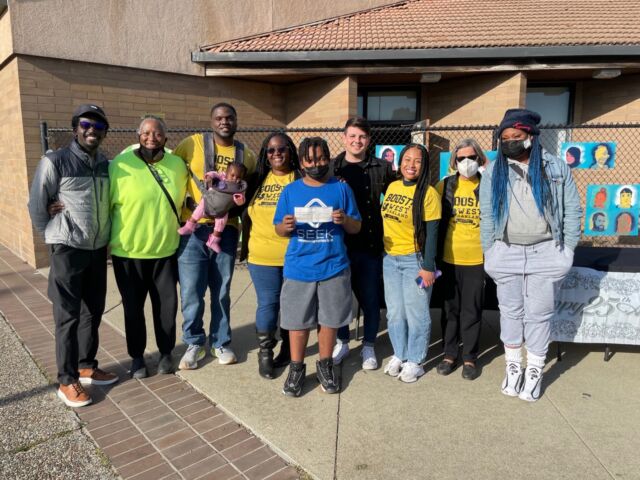 Cravotta poses with members of Boost! West Oakland after donating $50,000.