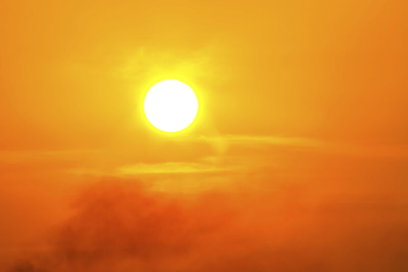 Image of the Sun in a hazy, orange sky.