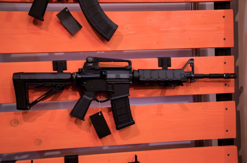 Rifles hanging on a gun rack.