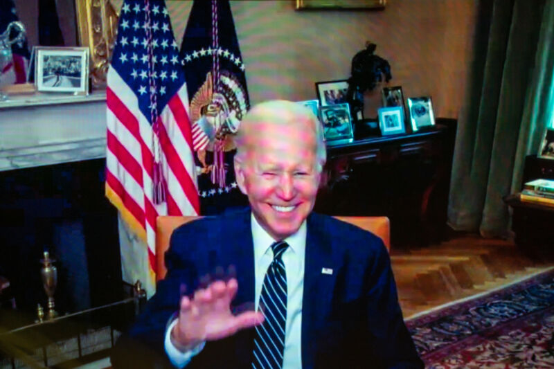 US President Joe Biden waves from his isolation following a virtual meeting on July 26, 2022. 