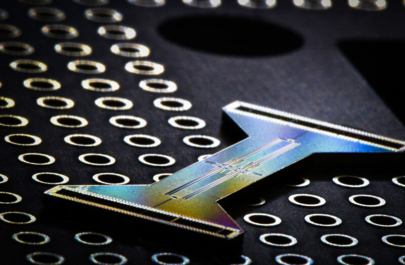 Image of an I-shaped piece of electronics on a dark background.