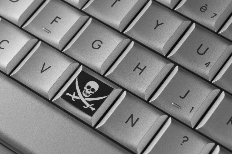 A computer keyboard with a pirate's skull and cutlasses symbol on one of the keys.