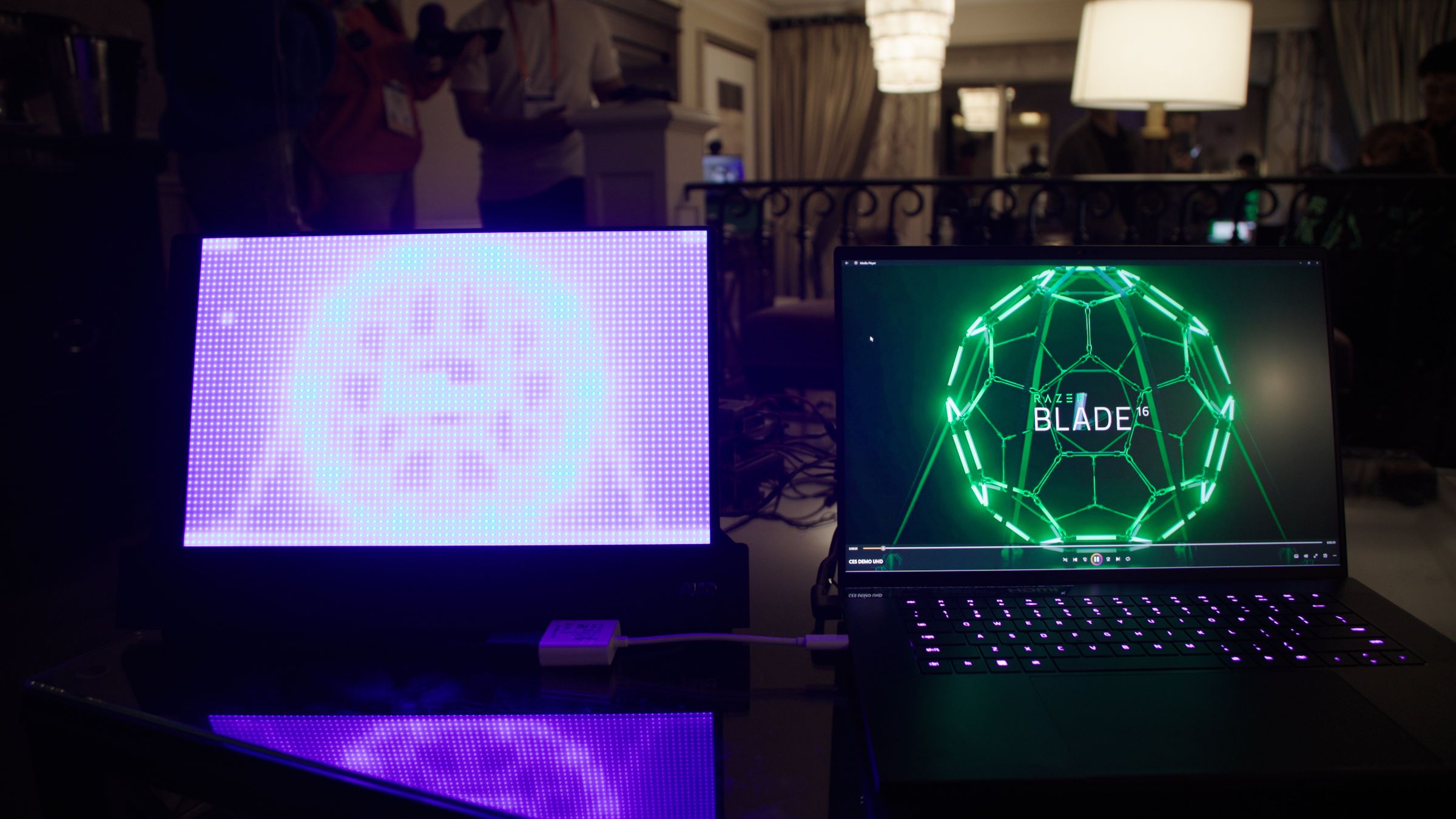 A Razer Blade 16 displaying the Razer Blade 16 logo next to a mirroring Mini LED display.