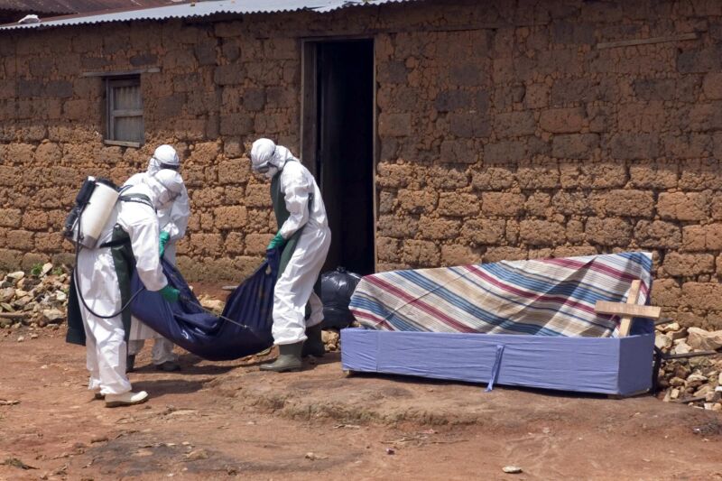 A World Health Organisation (WHO) alert team takes out a body in Nganakamana village near Uige on April 26, 2005. In outbreaks of viral haemorrhagic fevers, including Marburg, unprotected exposure to dead bodies is a significant cause of further spread.