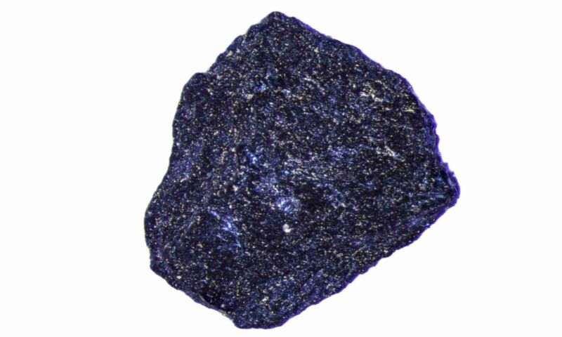 A small chunk of material, primarily blue with silvery speckles.