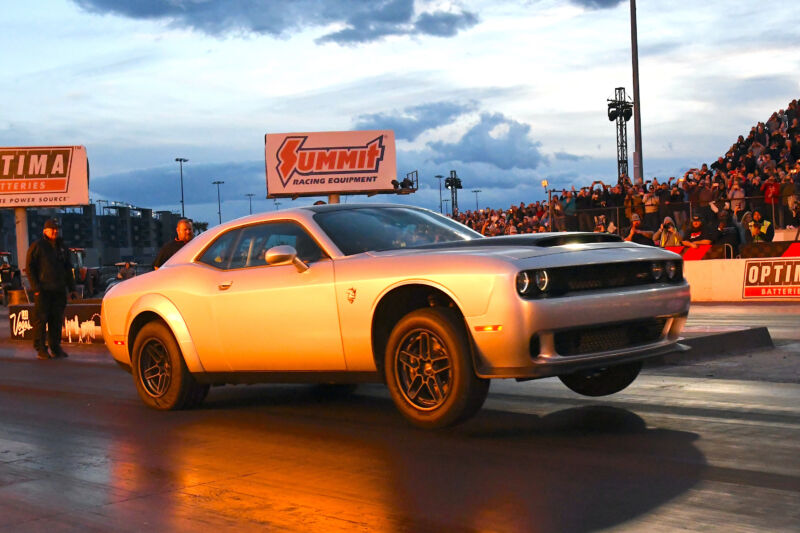 A Dodge Challenger SRT Demon 170 pulls a wheelie at the drag strip